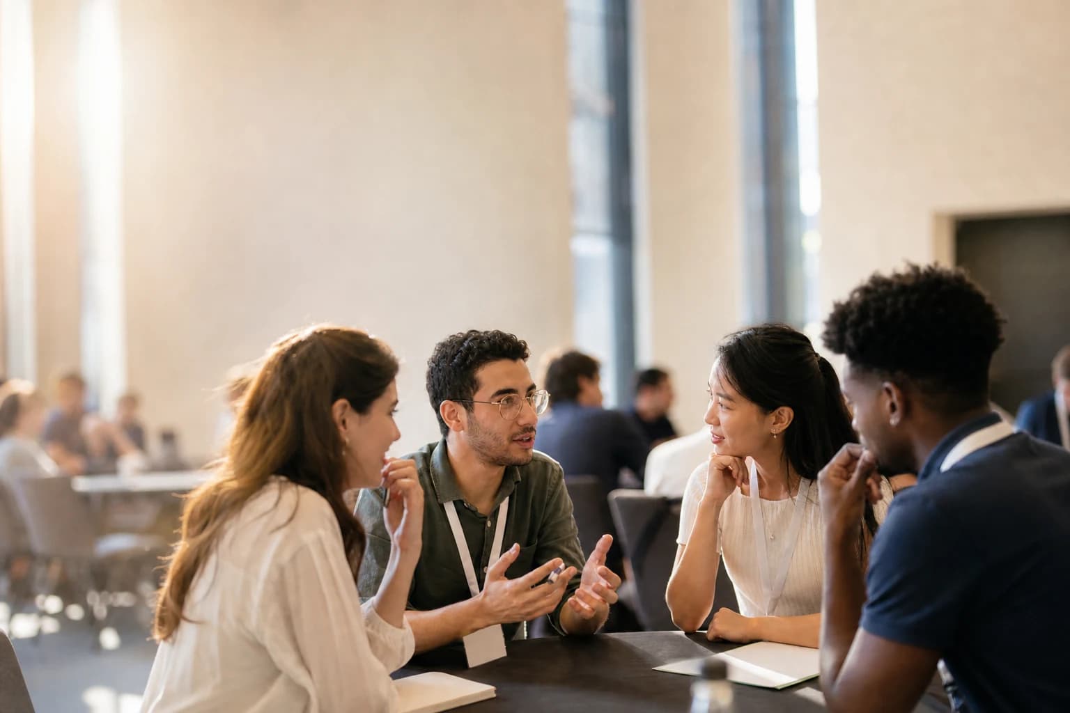International conference attendees in a thoughtful conversation